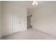 Neutral bedroom with soft carpet, bright walls, ceiling fan, and a door with stylish trim at 1621 Lakefield Cir, Gastonia, NC 28056