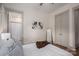 Bright bedroom featuring an ensuite bathroom, a modern mirror, and a neutral color palette at 1621 Lakefield Cir, Gastonia, NC 28056