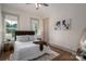 Comfortable bedroom with hardwood floors, two windows, and neutral decor at 1621 Lakefield Cir, Gastonia, NC 28056