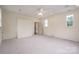 Spacious bonus room with neutral carpet, recessed lights, a ceiling fan, and two windows with leafy views at 1621 Lakefield Cir, Gastonia, NC 28056