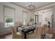 Elegant dining room with a chandelier, wainscoting, and stylish furniture at 1621 Lakefield Cir, Gastonia, NC 28056