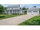 Inviting two-story home with a large front yard, driveway, and a detached three-car garage at 1621 Lakefield Cir, Gastonia, NC 28056