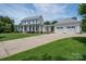 Inviting two-story home with a large front yard, driveway, and a detached three-car garage at 1621 Lakefield Cir, Gastonia, NC 28056