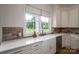 A farmhouse sink with window view is framed by ample counterspace and storage at 1621 Lakefield Cir, Gastonia, NC 28056
