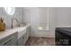 Bright laundry room featuring a farmhouse sink, designer faucet, and light-toned cabinetry at 1621 Lakefield Cir, Gastonia, NC 28056