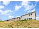 View of several home exteriors and lots, features manicured lawns and clear blue skies at 164 Shepherds Landing Dr, Mooresville, NC 28115