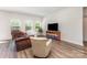 Bright living room with neutral walls, wood floors, and comfortable seating arrangement at 164 Shepherds Landing Dr, Mooresville, NC 28115