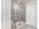 Modern shower features tiled walls, a glass door, and convenient built-in shelving at 164 Shepherds Landing Dr, Mooresville, NC 28115