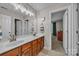 Bathroom featuring a double vanity with wooden cabinets and neutral tile floors at 1747 30Th Avenue Ne Dr, Hickory, NC 28601
