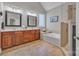 Bathroom featuring dual sinks, a glass enclosed shower, and a soaking tub beneath a window at 1747 30Th Avenue Ne Dr, Hickory, NC 28601