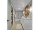 A bathroom featuring a toilet, sink, cabinets and vanity with a circular mirror plus shower at 1747 30Th Avenue Ne Dr, Hickory, NC 28601