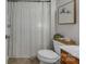 Cozy bathroom featuring a toilet, shower with patterned curtain, and vanity with small cabinet at 1747 30Th Avenue Ne Dr, Hickory, NC 28601
