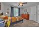 Bright bedroom with a ceiling fan, colorful striped bedding, desk, and a dresser at 1747 30Th Avenue Ne Dr, Hickory, NC 28601