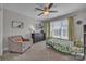 Inviting bedroom with a plush armchair, botanical theme, and a large window at 1747 30Th Avenue Ne Dr, Hickory, NC 28601