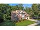 An eye-level view of the property with healthy grass, green shrubs, a large brick home, and a two-car garage at 1747 30Th Avenue Ne Dr, Hickory, NC 28601