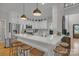 Modern kitchen with white cabinets, stainless steel appliances, countertop seating and hardwood floors at 1747 30Th Avenue Ne Dr, Hickory, NC 28601