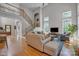 Open-concept living room with hardwood floors, large windows, and a staircase creates a modern and inviting space at 1747 30Th Avenue Ne Dr, Hickory, NC 28601
