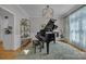 Elegant living room features a grand piano, stylish lighting, and decorative shelving providing a sophisticated ambiance at 1747 30Th Avenue Ne Dr, Hickory, NC 28601