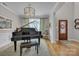 Bright and airy living room with a grand piano, a statement chandelier, and a decorative rug at 1747 30Th Avenue Ne Dr, Hickory, NC 28601