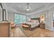 Spacious main bedroom with a tray ceiling, ceiling fan, natural light, and hardwood floors at 1747 30Th Avenue Ne Dr, Hickory, NC 28601