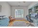 Bright home office with a large window, hardwood floors, and a stylish blue desk with shelving at 1747 30Th Avenue Ne Dr, Hickory, NC 28601