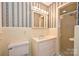 Bathroom featuring tiled walls, a shower, and a vanity with integrated sink and storage at 1961 Runnymede Ln, Charlotte, NC 28211