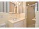 Bathroom featuring tiled walls, a shower, and a vanity with integrated sink and storage at 1961 Runnymede Ln, Charlotte, NC 28211