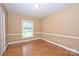 Light-filled bedroom with hardwood floors, neutral paint and trim, and large windows at 1961 Runnymede Ln, Charlotte, NC 28211