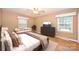 Bright bedroom features a queen-size bed, hardwood floors, lots of natural light, and a cozy seating area at 1961 Runnymede Ln, Charlotte, NC 28211