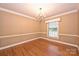 Elegant dining room featuring a classic chandelier, wainscoting, and large windows for natural light at 1961 Runnymede Ln, Charlotte, NC 28211