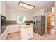 The kitchen features an island, stainless steel appliances, and access to the main room at 1961 Runnymede Ln, Charlotte, NC 28211