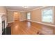 Bright living room featuring hardwood floors, a fireplace, and a view into the elegant dining room at 1961 Runnymede Ln, Charlotte, NC 28211