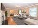 Comfortable living room featuring a stylish sofa, fireplace, and a glimpse into the dining area at 1961 Runnymede Ln, Charlotte, NC 28211