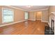 Inviting living room with hardwood floors, a fireplace, and bright windows for natural light at 1961 Runnymede Ln, Charlotte, NC 28211