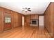 The living room features hardwood floors, wood paneling, and a brick fireplace at 1961 Runnymede Ln, Charlotte, NC 28211