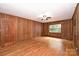 The living room features hardwood floors, wood paneling, and a large window at 1961 Runnymede Ln, Charlotte, NC 28211