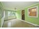 Bright and airy sunroom with lots of windows, green walls, and tile floors at 1961 Runnymede Ln, Charlotte, NC 28211