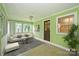 Inviting sunroom with tile floors, lots of windows, and neutral seating arrangements at 1961 Runnymede Ln, Charlotte, NC 28211