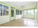 Bright sunroom featuring multiple windows, ceiling fan, and neutral color scheme, great for relaxing and enjoying natural light at 1961 Runnymede Ln, Charlotte, NC 28211