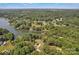 Expansive aerial shot of a lake surrounded by dense trees and charming houses, offering a peaceful retreat at 2010 Dogwood Trl, Shelby, NC 28150
