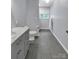 Modern bathroom with gray tile flooring, a marble countertop, and updated fixtures at 2010 Dogwood Trl, Shelby, NC 28150