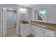 Bathroom featuring granite counters, white cabinets, and a tile floor at 2010 Dogwood Trl, Shelby, NC 28150