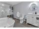 Bright bathroom with a glass shower, a soaking tub, and gray tile floors at 2010 Dogwood Trl, Shelby, NC 28150