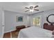 Bedroom featuring wood floors, ceiling fan, door to the deck, and a wooden chest at 2010 Dogwood Trl, Shelby, NC 28150