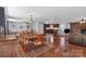 Open concept dining room with hardwood floors, brick fireplace, and seamless kitchen access at 2010 Dogwood Trl, Shelby, NC 28150