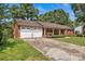 Charming brick home featuring an attached two-car garage and a welcoming covered front porch at 2010 Dogwood Trl, Shelby, NC 28150