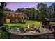 Inviting backyard fire pit area with seating, perfect for evening gatherings and relaxation at 2010 Dogwood Trl, Shelby, NC 28150