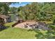 Backyard fire pit area with seating and a tranquil lake view, creating a perfect outdoor oasis at 2010 Dogwood Trl, Shelby, NC 28150