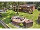 A serene backyard with a stone fire pit area, surrounded by lush lawn and mature trees at 2010 Dogwood Trl, Shelby, NC 28150