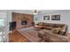 Spacious living room featuring a brick fireplace, hardwood floors, and comfortable leather seating at 2010 Dogwood Trl, Shelby, NC 28150